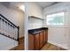 Hallway includes storage cabinets with dark countertop and a large window for natural light at 1348 Green Oaks Ln # L, Charlotte, NC 28205