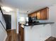 Functional kitchen area featuring wood cabinets, stainless steel appliances, and a convenient breakfast bar at 1348 Green Oaks Ln # L, Charlotte, NC 28205
