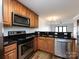 Well-equipped kitchen with stainless steel appliances, stylish cabinetry, and sleek granite countertops overlooking a spacious living area at 1348 Green Oaks Ln # L, Charlotte, NC 28205