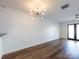 Bright living room showcasing hardwood floors, modern lighting, and access to a private outdoor space at 1348 Green Oaks Ln # L, Charlotte, NC 28205