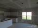Bright, spacious kitchen featuring white cabinetry, a center island, and large window allowing natural light at 145 Mason Tanner Ct, Rock Hill, SC 29730