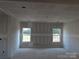 Spacious living room with natural light flooding through bright windows, awaiting personalized finishing touches at 145 Mason Tanner Ct, Rock Hill, SC 29730