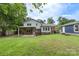 Large backyard with a covered patio, a detached garage, and a well-maintained lawn at 15333 Catawba S Cir, Matthews, NC 28104
