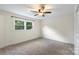 Cozy bedroom with carpet and a ceiling fan, offering a relaxing space at 15333 Catawba S Cir, Matthews, NC 28104
