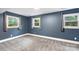 Comfortable bedroom with plush gray carpeting, soothing blue walls, and bright, natural light at 15333 Catawba S Cir, Matthews, NC 28104