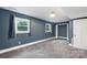 Spacious bedroom featuring two windows, new gray carpeting, and fresh, neutral paint at 15333 Catawba S Cir, Matthews, NC 28104