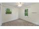 Neutral bedroom with natural light from two windows and plush carpet flooring at 15333 Catawba S Cir, Matthews, NC 28104