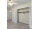 Neutral bedroom featuring closet with folding doors and doorway to the next room at 15333 Catawba S Cir, Matthews, NC 28104