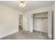 Neutral bedroom with folding closet doors featuring doorway to the next room at 15333 Catawba S Cir, Matthews, NC 28104