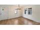 Well-lit dining room with hardwood floors, chandelier, and large windows at 15333 Catawba S Cir, Matthews, NC 28104