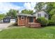 Charming brick home with a well-maintained lawn and a detached blue garage at 15333 Catawba S Cir, Matthews, NC 28104