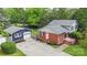 Home exterior view showing brick accents, a detached garage, and well-maintained landscaping at 15333 Catawba S Cir, Matthews, NC 28104