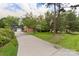 Home exterior view with a long driveway, landscaped yard, and a detached garage at 15333 Catawba S Cir, Matthews, NC 28104