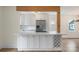 Bright, modern kitchen with white cabinets, stainless steel appliances, and a wine rack at 15333 Catawba S Cir, Matthews, NC 28104