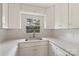 Updated kitchen features white cabinets, quartz countertops, and a subway tile backsplash at 15333 Catawba S Cir, Matthews, NC 28104