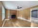 Living room featuring wood paneled walls, brick fireplace, and hardwood floors at 15333 Catawba S Cir, Matthews, NC 28104