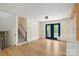Spacious living room features hardwood floors and stylish blue french doors at 15333 Catawba S Cir, Matthews, NC 28104