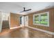 Bright living room featuring wood paneling, hardwood floors, and natural light from large windows at 15333 Catawba S Cir, Matthews, NC 28104