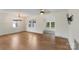 Bright living space with hardwood floors, TV and windows to the side yard at 15333 Catawba S Cir, Matthews, NC 28104