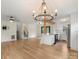Open-concept living space with hardwood floors, kitchen, and staircase at 15333 Catawba S Cir, Matthews, NC 28104