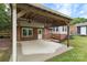 Covered patio with wooden pergola, concrete flooring, brick walls, and ceiling fans at 15333 Catawba S Cir, Matthews, NC 28104