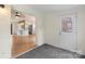 Carpeted room featuring an adjacent door and view of the kitchen at 15333 Catawba S Cir, Matthews, NC 28104
