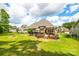 Spacious backyard with lush greenery, a patio, a deck, and ample space for relaxation and entertainment at 1655 Essex Hall Dr, Rock Hill, SC 29730