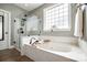 This bathroom features a glass-enclosed shower and a soaking tub with a faucet at 1655 Essex Hall Dr, Rock Hill, SC 29730