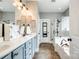 This bathroom features double sinks, tiled floors, tub, and a glass-enclosed shower at 1655 Essex Hall Dr, Rock Hill, SC 29730