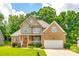 Charming two-story brick and siding home with a well-manicured lawn and an inviting front porch at 1655 Essex Hall Dr, Rock Hill, SC 29730