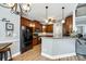 Kitchen boasts wooden cabinets, granite countertops, stainless steel appliances, and hardwood floors at 1655 Essex Hall Dr, Rock Hill, SC 29730