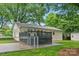 Home backyard with a gray wood deck, fenced yard, green grass, and a storage building at 1700 Emerywood Dr, Charlotte, NC 28210