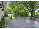 View from the back yard deck, overlooking the fenced yard and lush greenery at 1700 Emerywood Dr, Charlotte, NC 28210