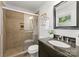 Bathroom featuring a granite topped vanity, framed mirror, and a tiled shower with sliding glass door at 1700 Emerywood Dr, Charlotte, NC 28210