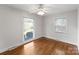 Sunny bedroom with hardwood floors, ceiling fan, and multiple large windows at 1700 Emerywood Dr, Charlotte, NC 28210