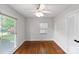 Sunny bedroom with hardwood floors, ceiling fan, and multiple large windows at 1700 Emerywood Dr, Charlotte, NC 28210