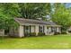 Well-maintained brick home with black shutters, a manicured lawn, and tasteful landscaping in a lush setting at 1700 Emerywood Dr, Charlotte, NC 28210