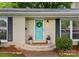 Close-up of the front entrance featuring a blue door with wreath, planters, and brick facade at 1700 Emerywood Dr, Charlotte, NC 28210