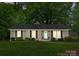 Charming single-story brick home featuring a well-manicured lawn and inviting front entrance with black shutters at 1700 Emerywood Dr, Charlotte, NC 28210
