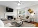 Inviting living room featuring a fireplace, cozy seating, and natural light from large windows at 1700 Emerywood Dr, Charlotte, NC 28210