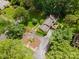 Aerial view of a secluded home surrounded by mature trees, lush greenery, and a circular driveway at 2000 Ferncliff Rd, Charlotte, NC 28211