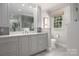 The spacious bathroom features a double sink vanity with marble countertops, plus a separate toilet area at 2000 Ferncliff Rd, Charlotte, NC 28211