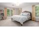 This bright bedroom features large windows with attractive curtains and plush carpeting at 2000 Ferncliff Rd, Charlotte, NC 28211