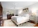 This bedroom offers a plush bed and a beautiful antique wooden dresser and wood floors at 2000 Ferncliff Rd, Charlotte, NC 28211