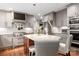 Modern kitchen features granite countertops, stainless steel appliances, island, and hardwood floors at 2000 Ferncliff Rd, Charlotte, NC 28211