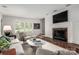 Comfortable living room features a fireplace, large windows with shutter blinds, and neutral decor at 2000 Ferncliff Rd, Charlotte, NC 28211
