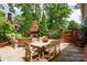 Enjoy outdoor gatherings on the stone patio, which features a dining area and an outdoor fireplace at 2000 Ferncliff Rd, Charlotte, NC 28211