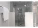 The large shower has beautiful marble tiling and a glass door, offering a clean, modern look at 2000 Ferncliff Rd, Charlotte, NC 28211