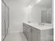 Bright bathroom featuring a double vanity, stone counters, modern fixtures, and a glass-enclosed shower at 2134 Barrowcliffe Nw Dr # 0006, Concord, NC 28027