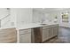 Modern kitchen with stainless steel appliances, large island, white countertops, and hardwood flooring at 2134 Barrowcliffe Nw Dr # 0006, Concord, NC 28027